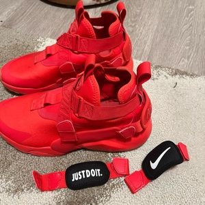 Red Nike Air shoes with two sets of back panels. Women’s 9, gently used